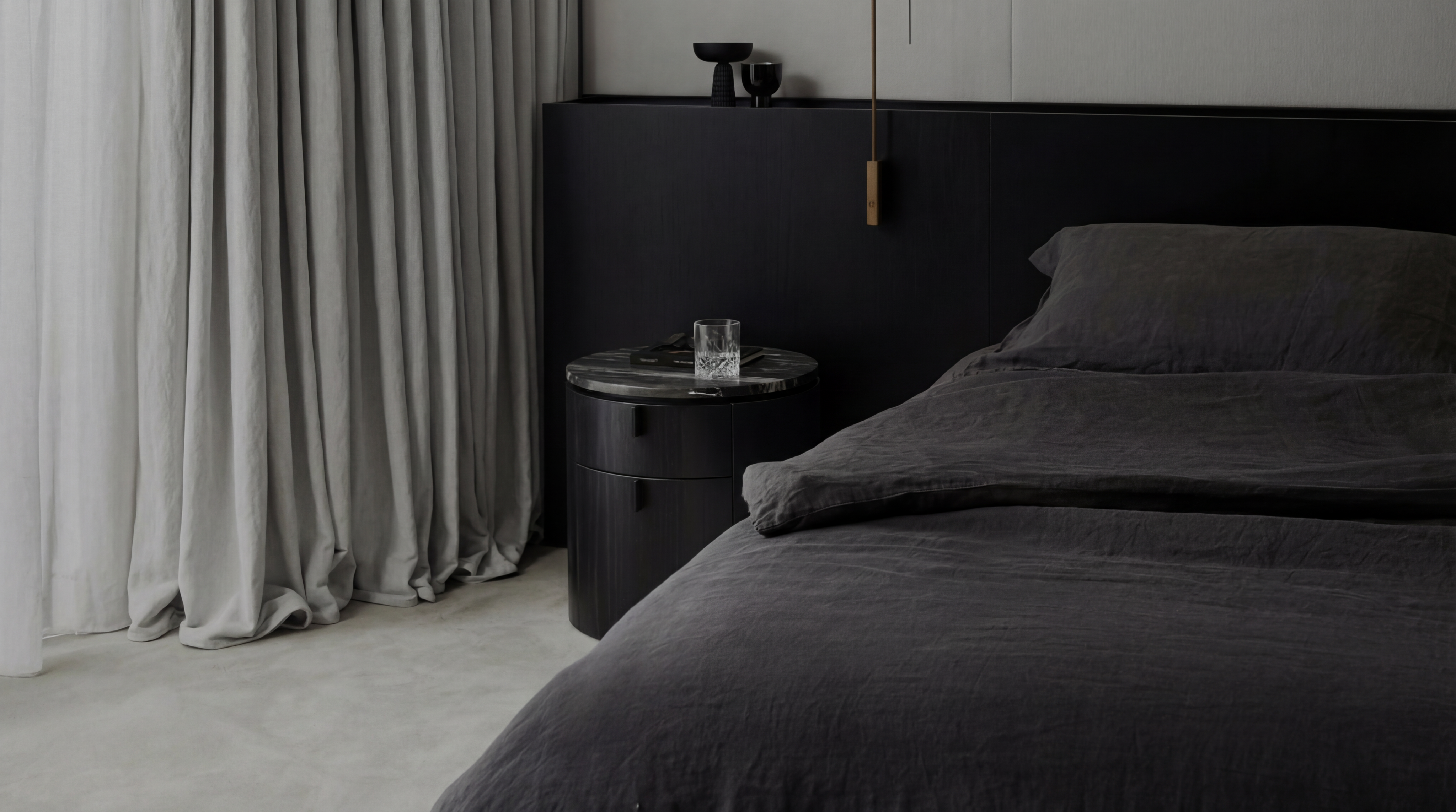 Two women sitting at a modern table talking with a city view behind them.